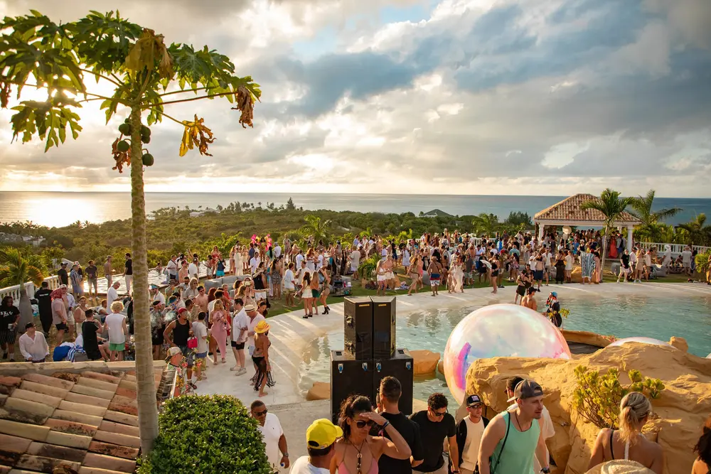 Crowd dancing at a villa party at sunset in Saint-Martin.