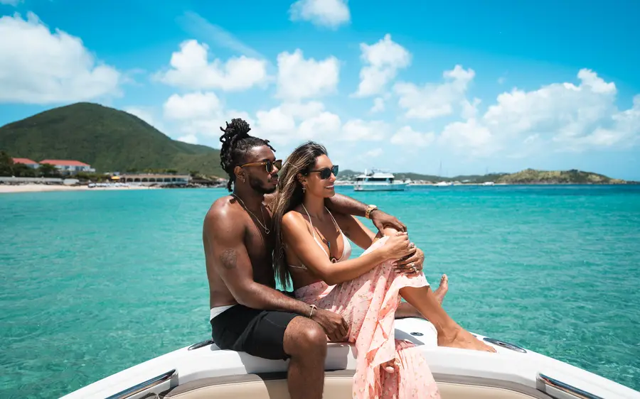 Couple sitting at the bow of a boat.