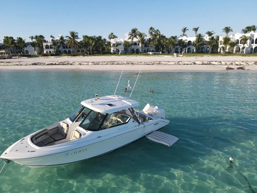 Motor boat anchored in clear turquoise water.