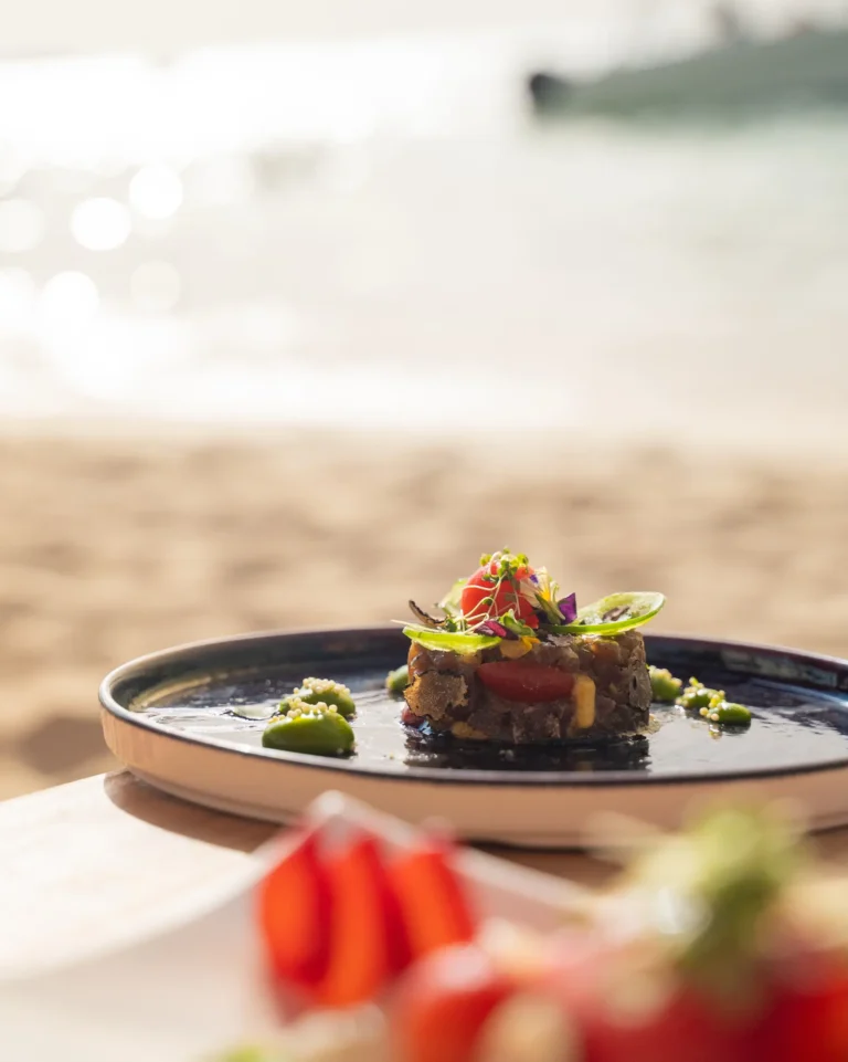 Gourmet plate on a beach table.