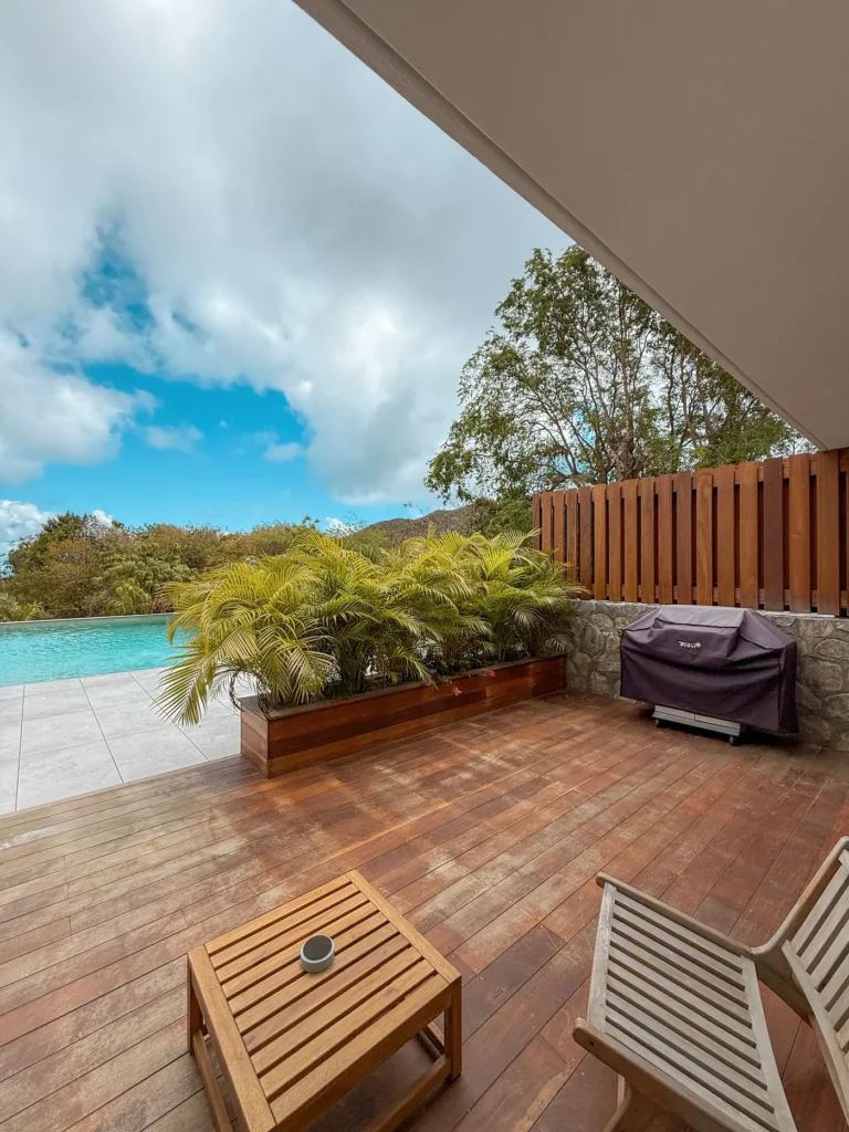 Wooden terrace with lounge chairs and ocean view.