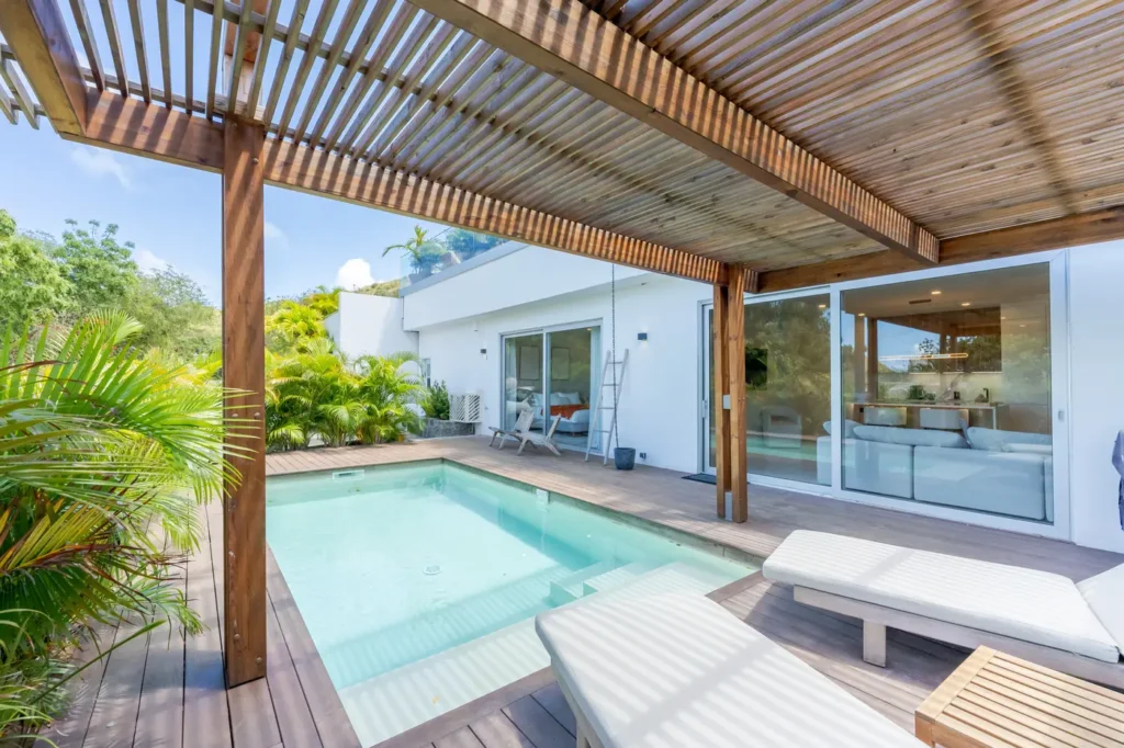 Private pool and terrace under a wooden pergola.