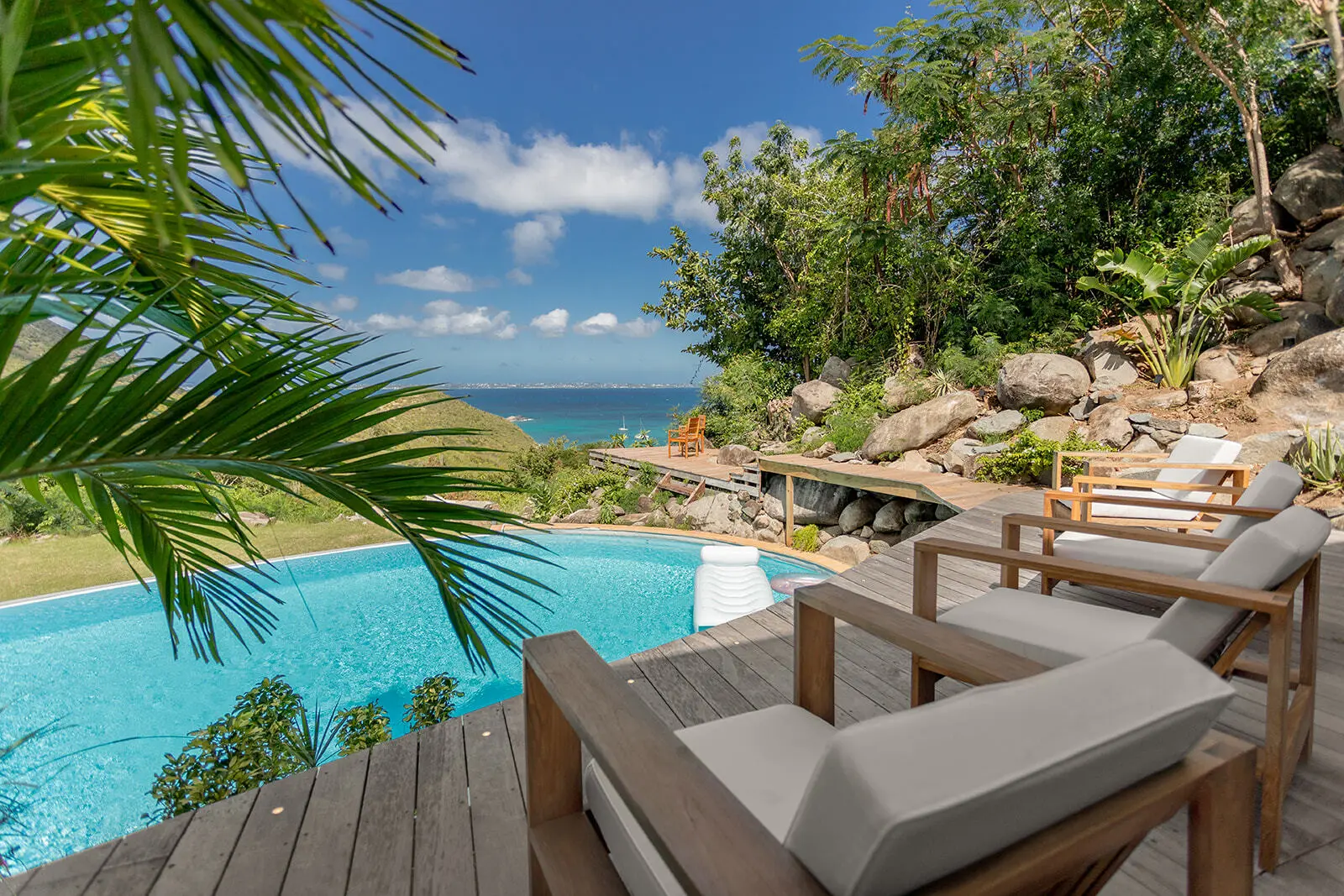 Infinity pool and loungers overlooking the bay.