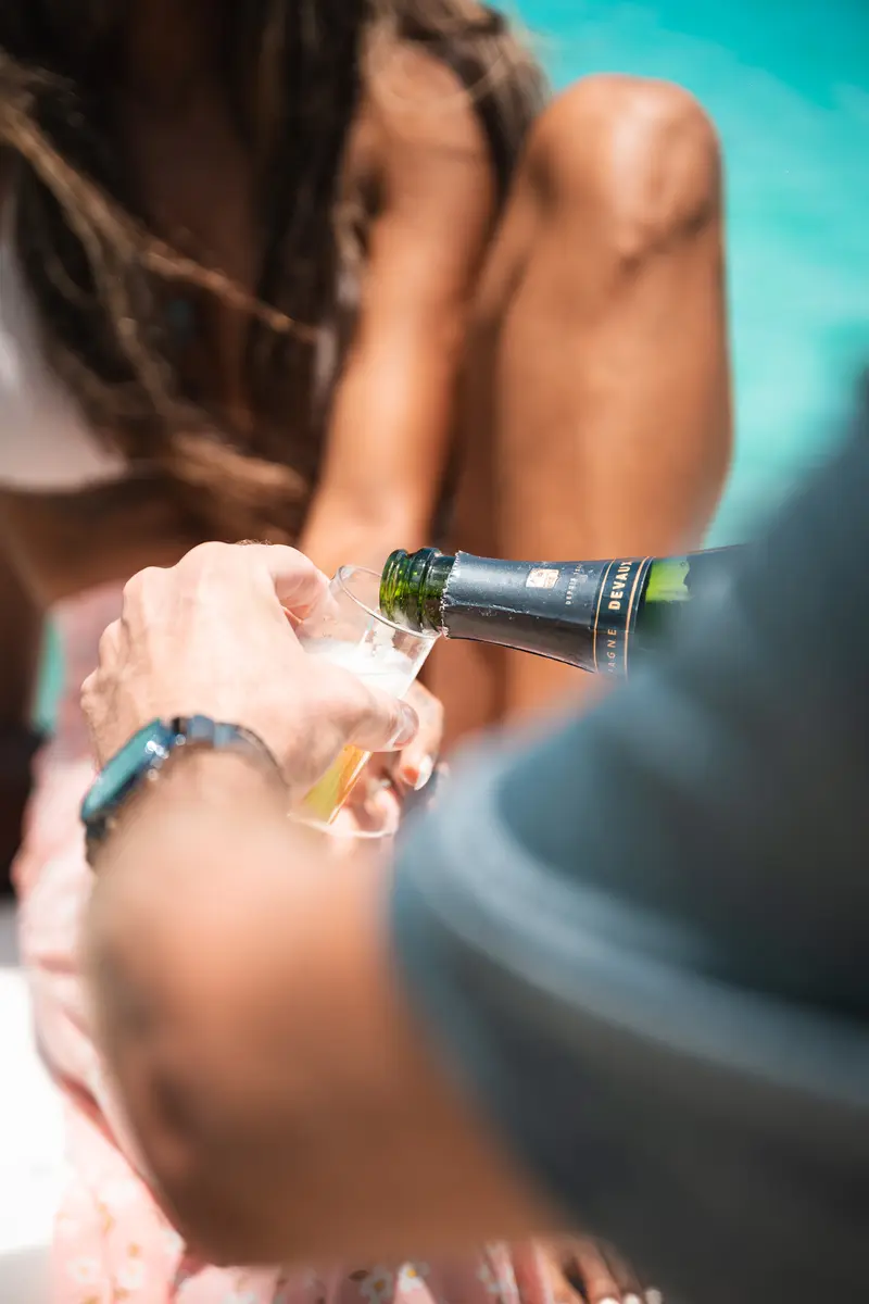 Champagne bottle being opened on board.