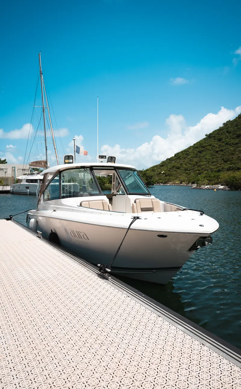 The Aura boat moored at the marina pontoon.