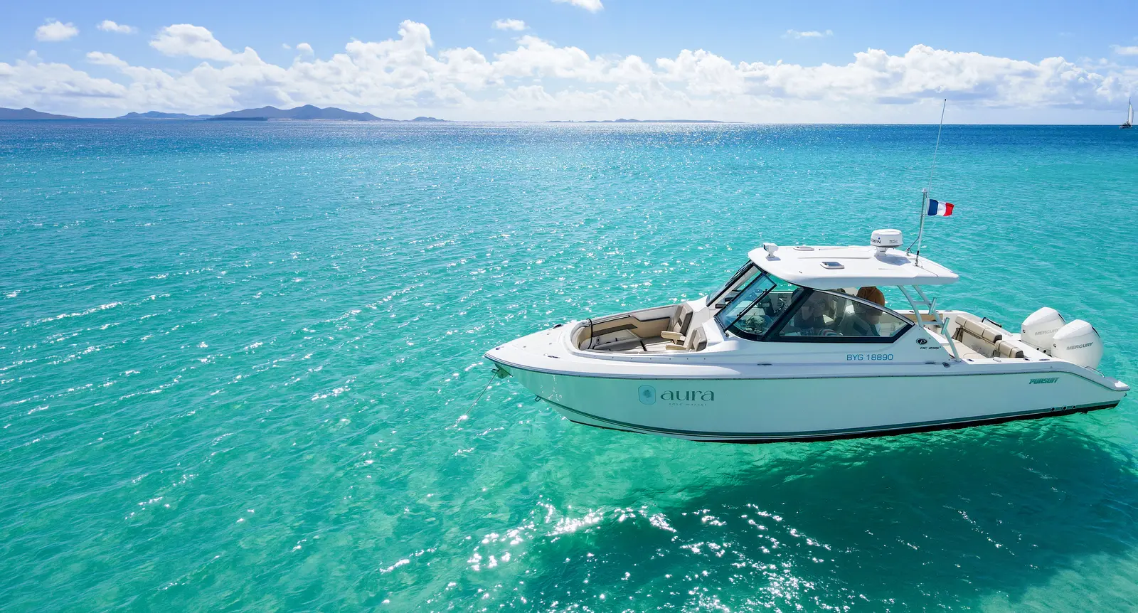 The Aura yacht on turquoise water.