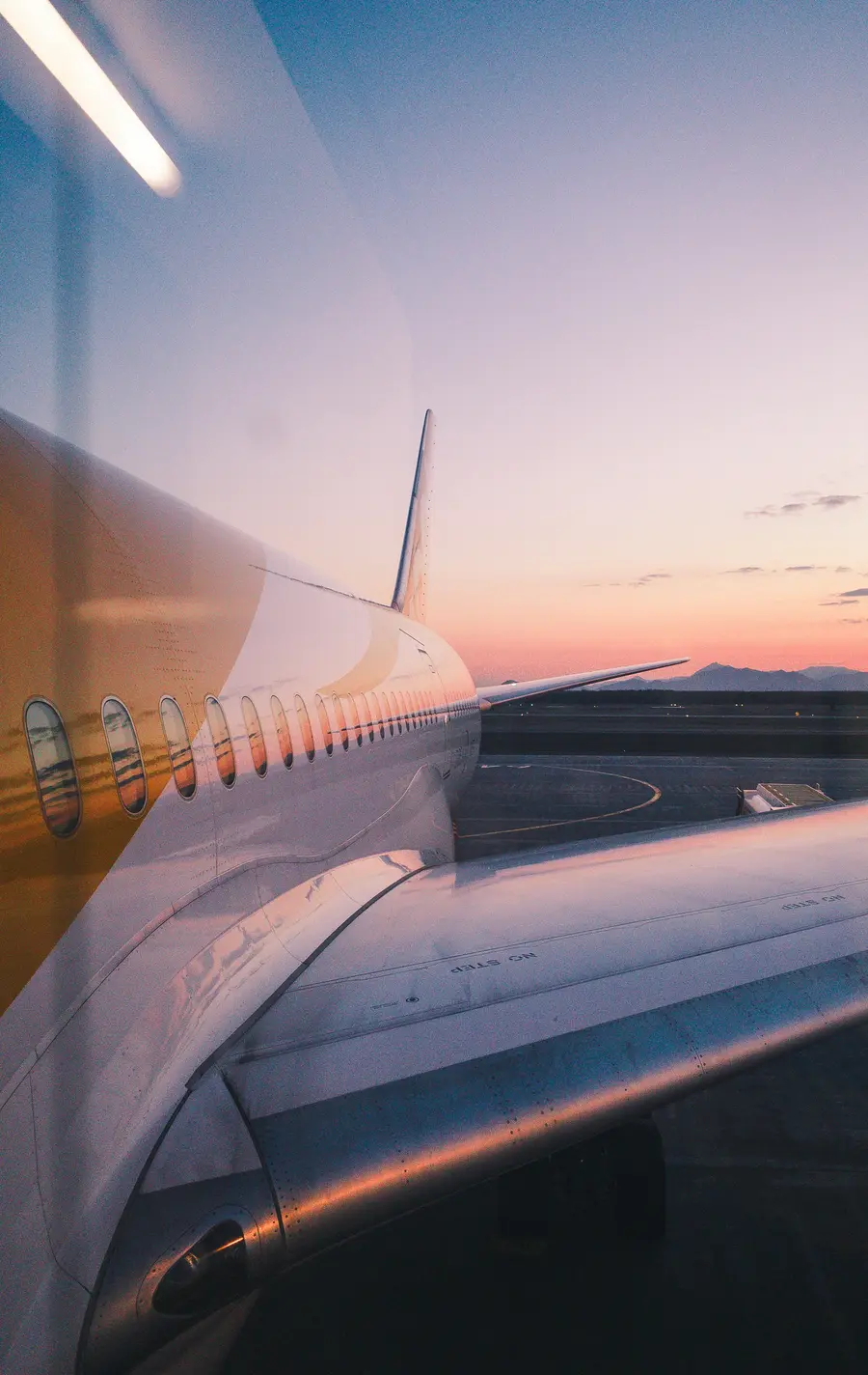 Airplane wing at sunset.