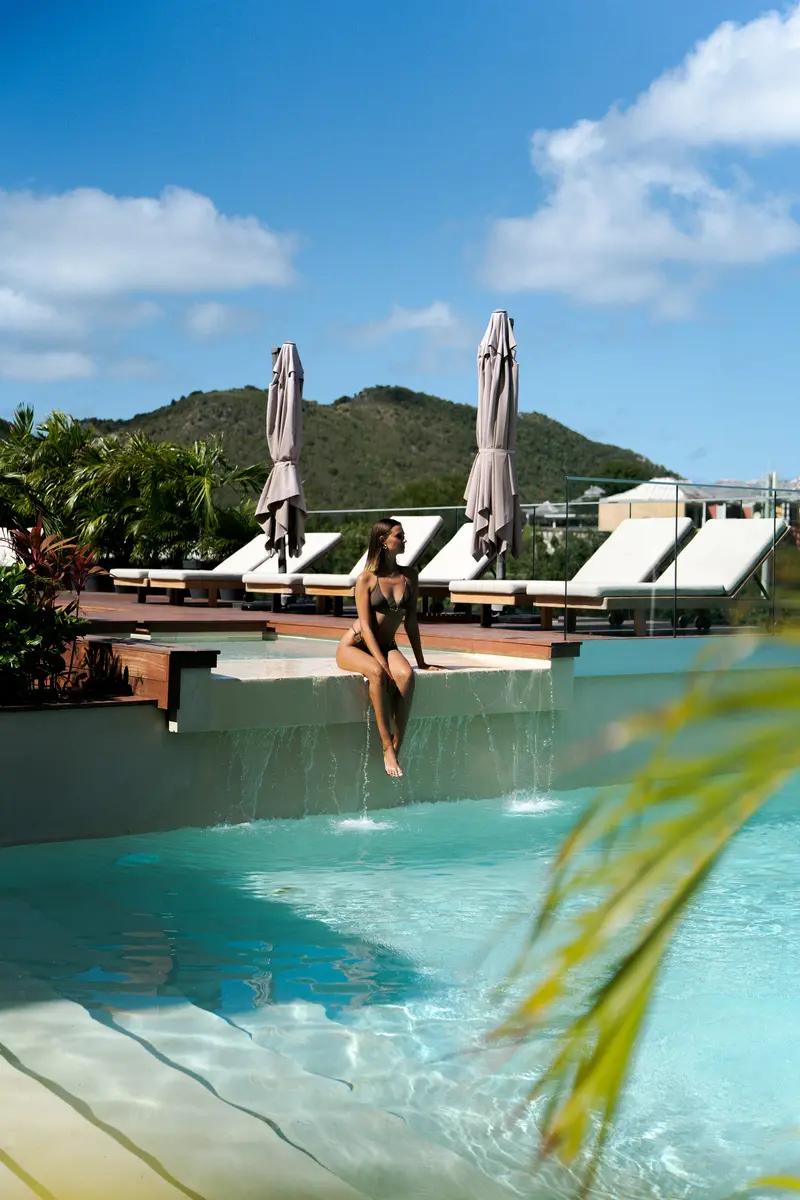 Woman relaxing at the edge of the infinity pool.