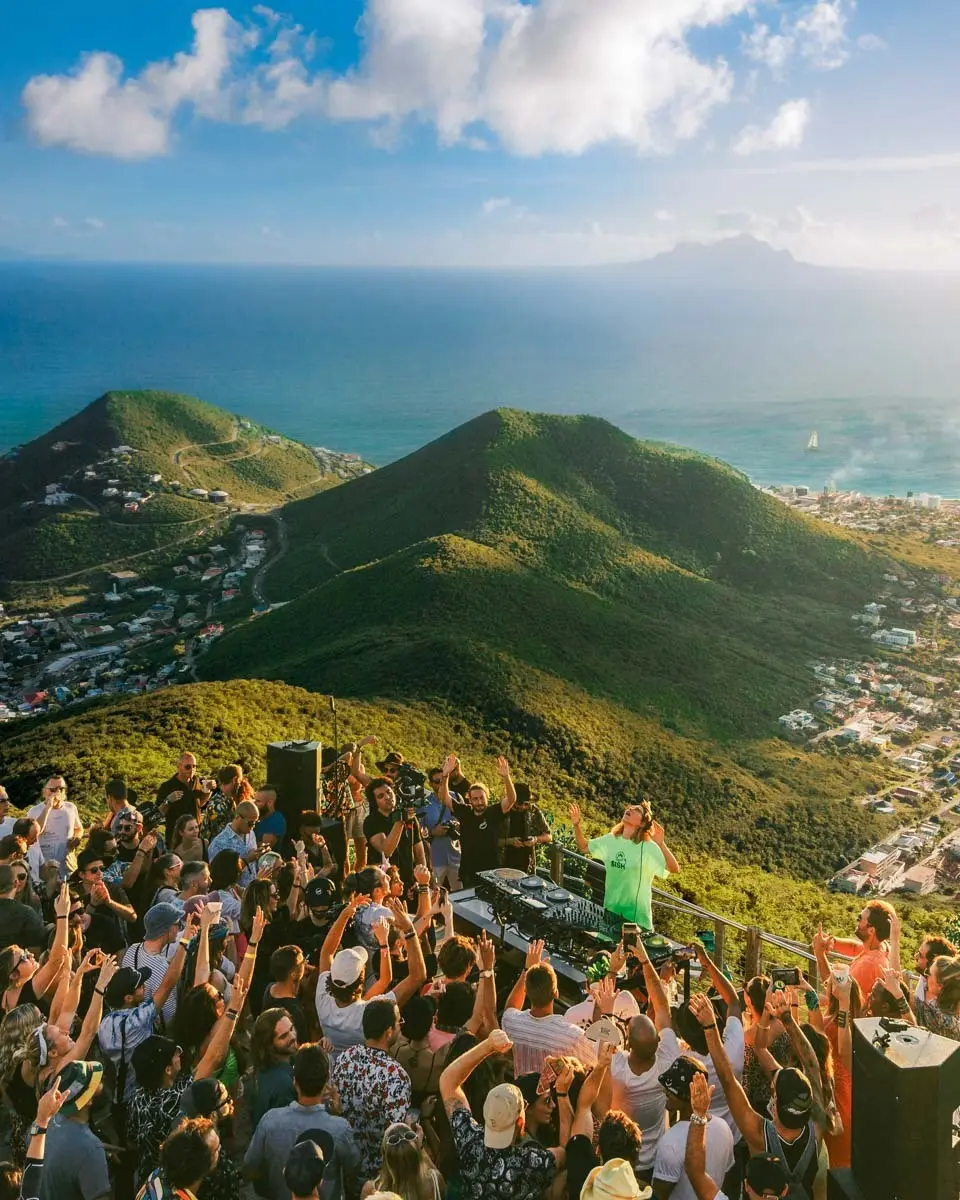 Crowd dancing on a hilltop above the island.