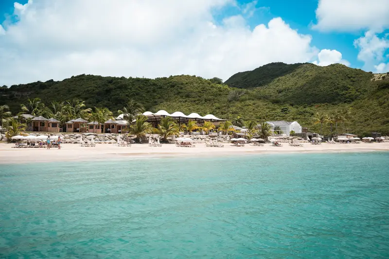 Beach with parasols and turquoise water.